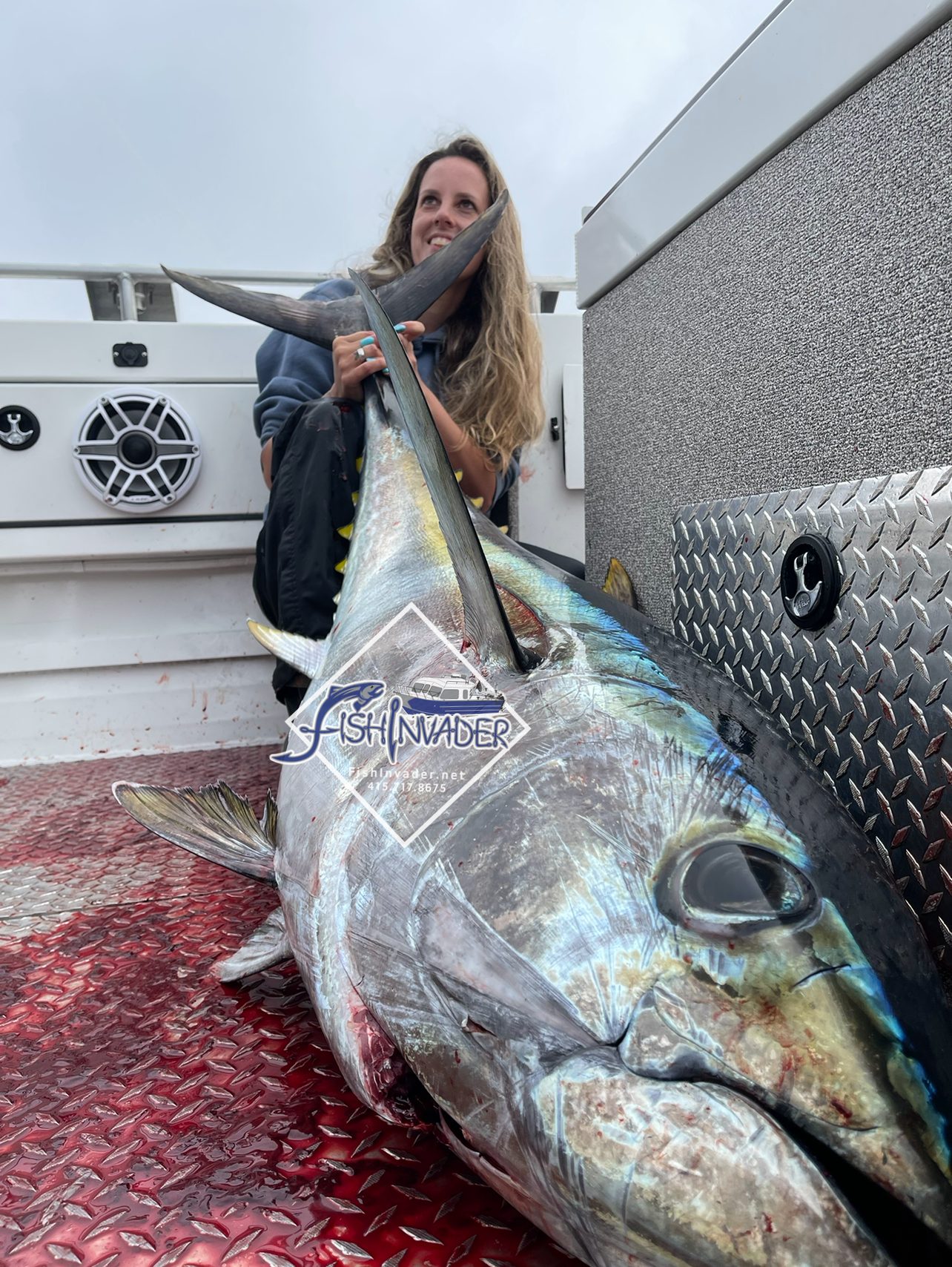 Captain Stephanie with a big bluefin tuna on the deck of the Fish Invader