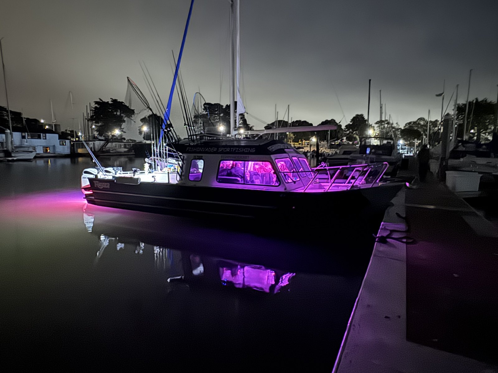 The Fish Invader lit up at the dock at night